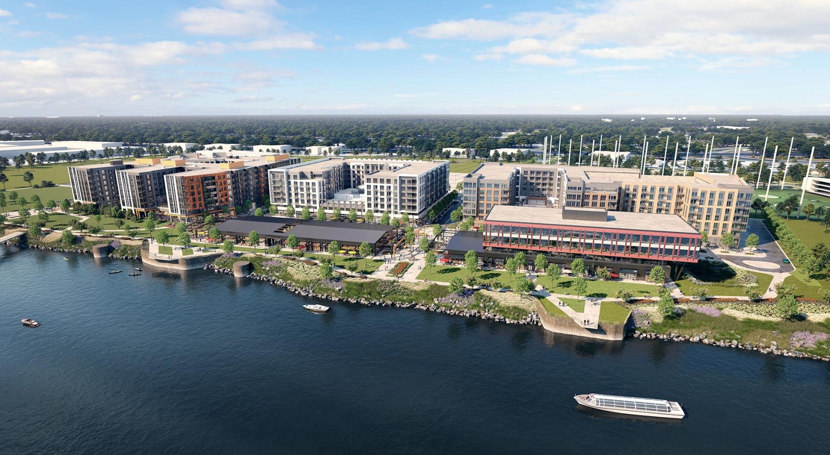 A perfect fit for the whole family Aerial view of The Wayward apartments in Nashville, TN, featuring a modern exterior and boats in the river.